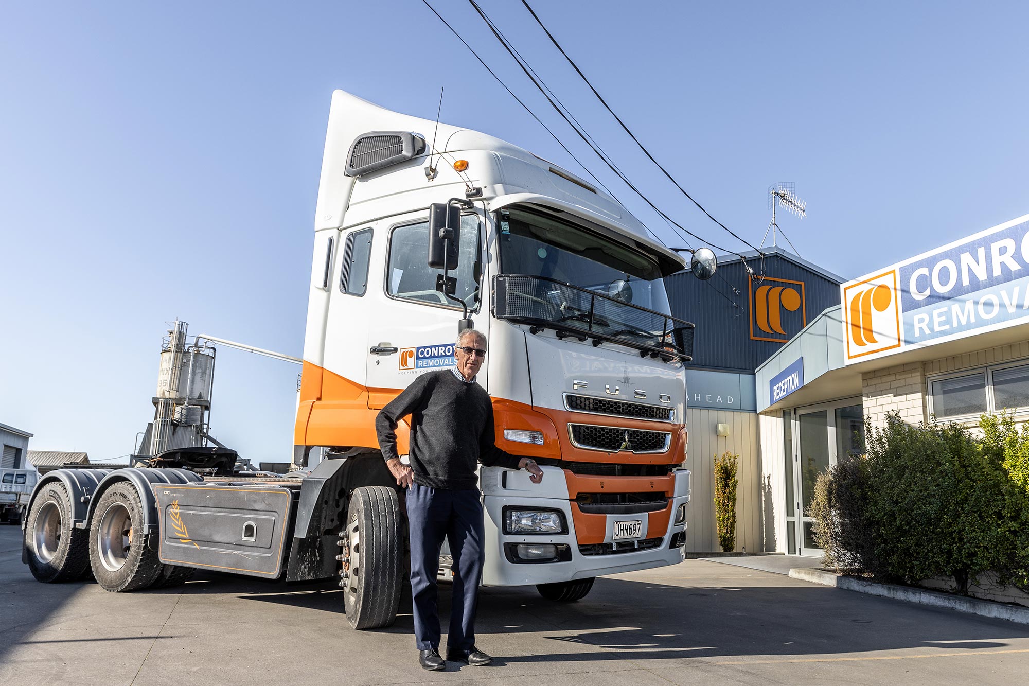 Conroy Removals founder David Conroy sitting in a FUSO truck 