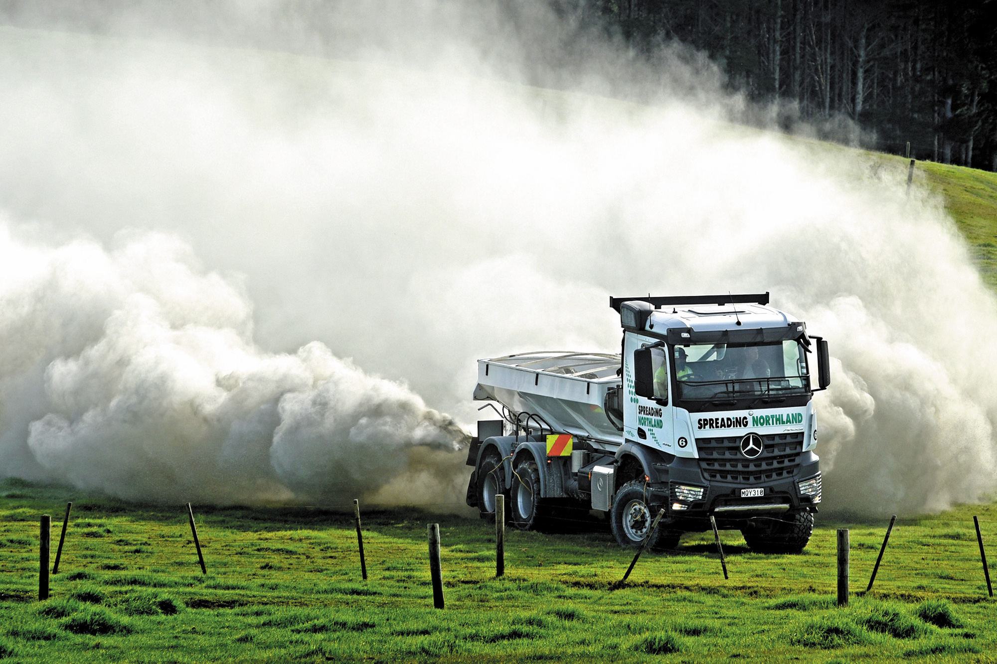 A Mercedes-Benz Arocs spreads in a field in New Zealand