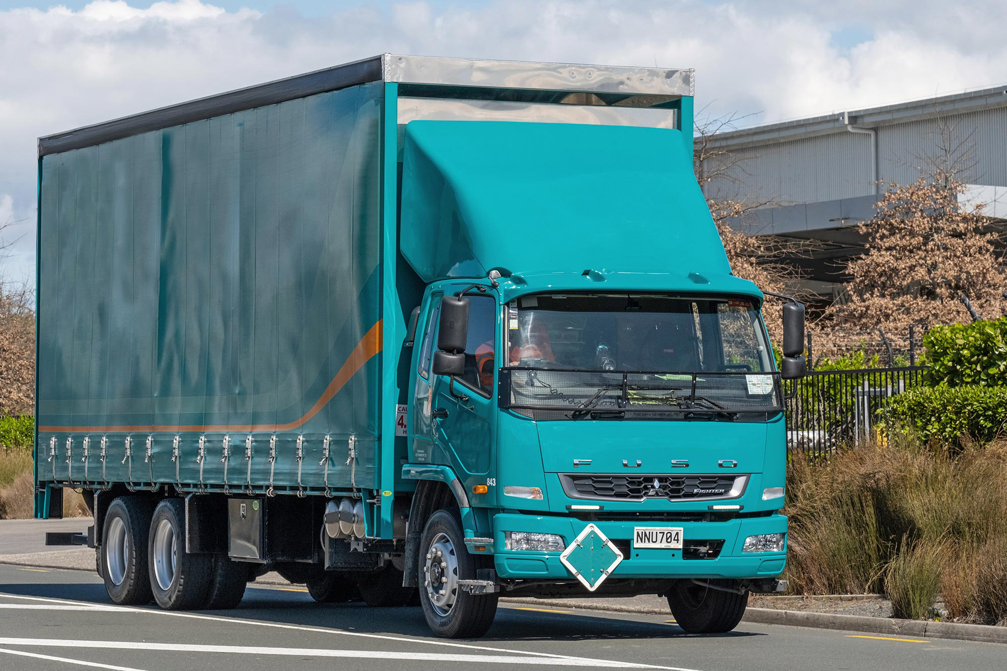 A FUSO Figher waiting at a depo 