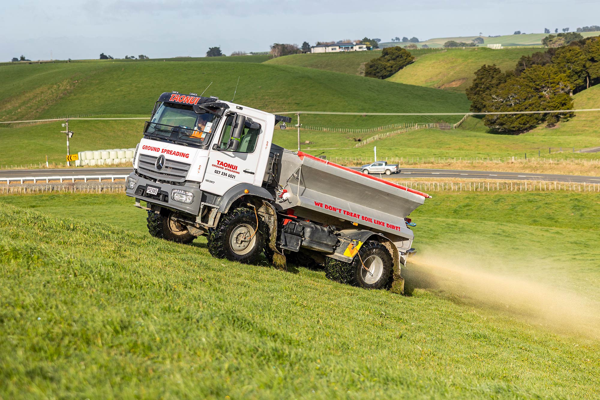 A Mercedes-Benz Atego spreading in the field 