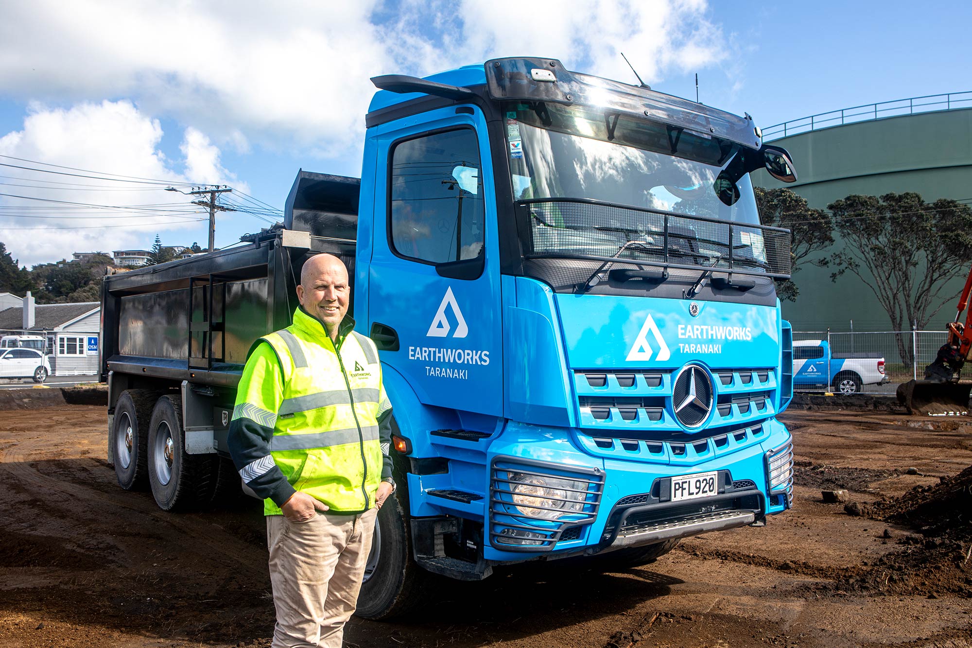 Earthworks Taranaki director Rodney next to his Mercedes-Benz Arocs 