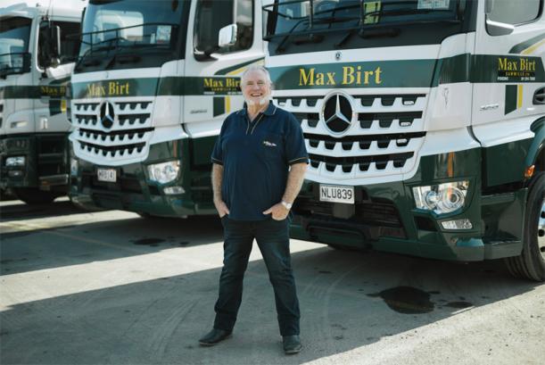 Max Birt next to a heavy duty Mercedes-Benz Arocs